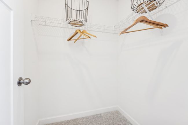 Photo is of the actual model. The primary bedroom features an incredible walk-in closet. | Image 23
