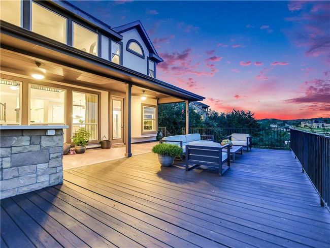 Deck at dusk with an outdoor hangout area | Image 5