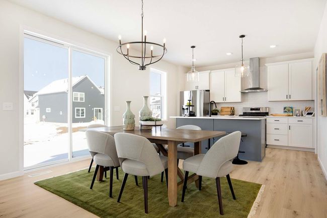 The well-appointed and organized kitchen is designed for both style and functionality. It features sleek, stainless steel appliances, including a modern LG gas range. Photos are from previously built home; options and features will vary. | Image 7