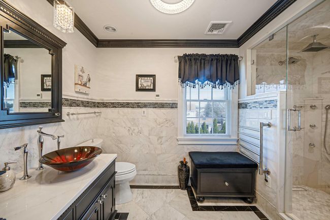 Bathroom with a stall shower, crown molding, toilet, vanity, and visible vents | Image 19