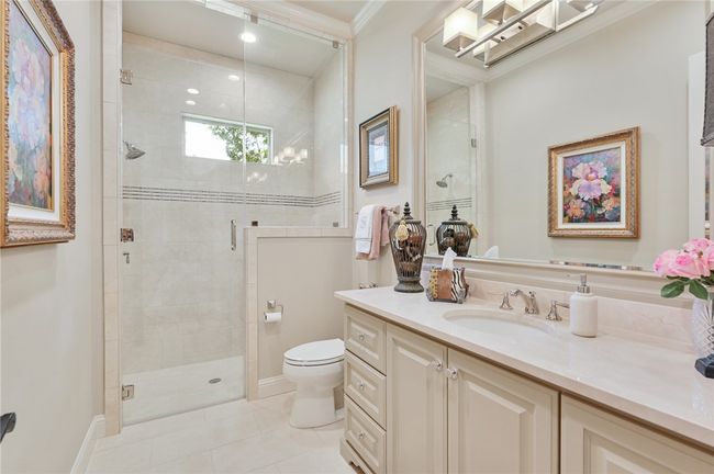 Full bathroom with vanity, toilet, a stall shower, tile patterned floors, and ornamental molding | Image 6