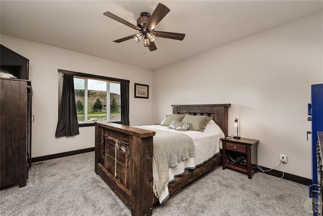 Primary bedroom, ceiling fan from 9' ceiling, carpeted. | Image 14