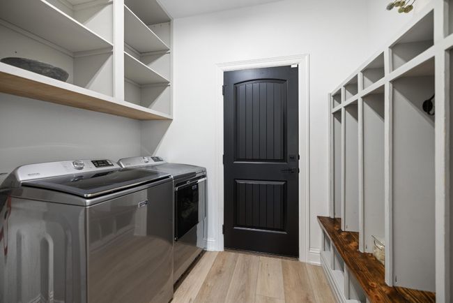 Clothes washing area with laundry area, washer and clothes dryer, and light wood finished floors | Image 37