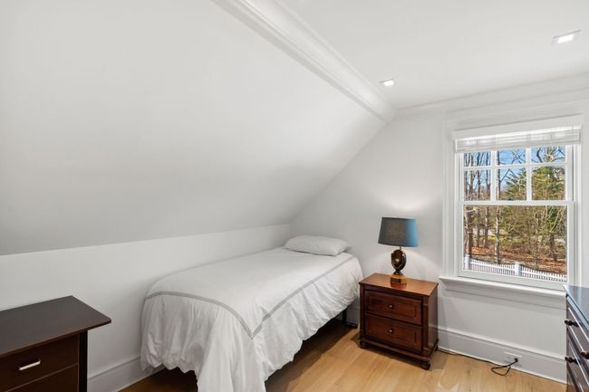 Bedroom featuring ornamental molding, light hardwood / wood-style flooring, and lofted ceiling | Image 33