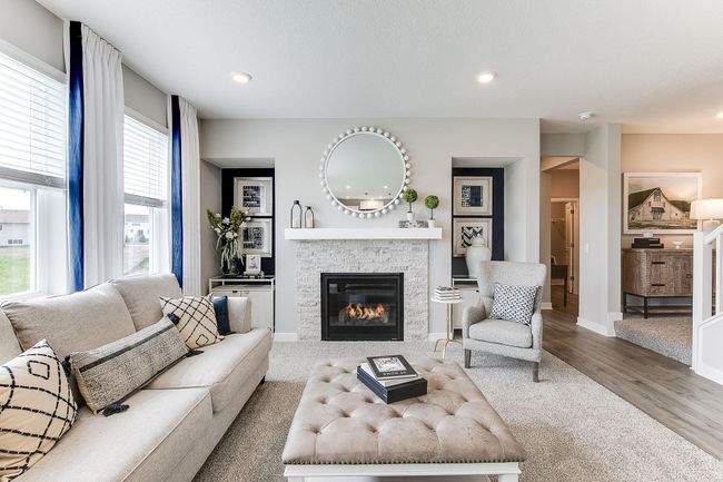 Family room with gas fireplace, abundant space to gather. Photo of model home, color & options may vary. | Image 11