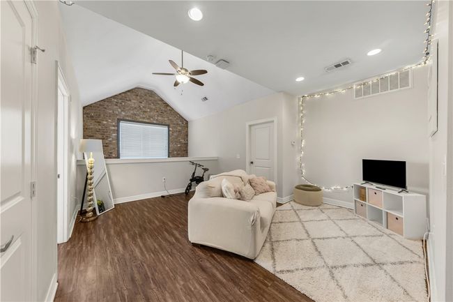 Living room featuring lofted ceiling, hardwood / wood-style floors, and ceiling fan | Image 24