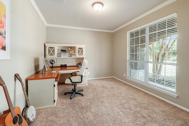 The dedicated office, located at the front of the home, offers a quiet, productive space with plenty of natural light, making it ideal for work or focus | Image 9