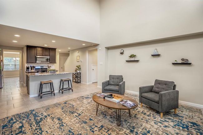 A view from the den area looking to the kitchen, you will notice there is an insert which would be ideal for a TV Console. | Image 19