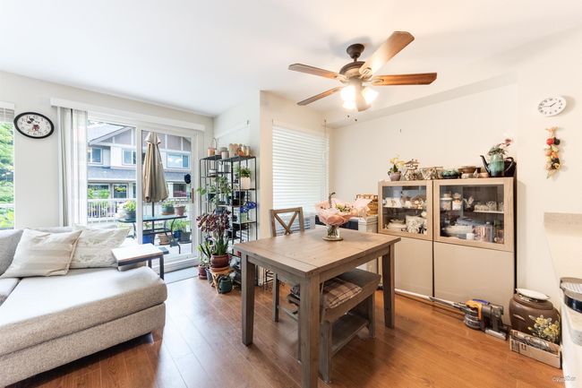 Dining room with a ceiling fan and wood finished floors | Image 4