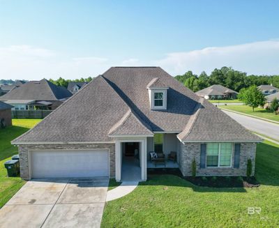 View of front facade featuring a front yard and a garage | Image 1