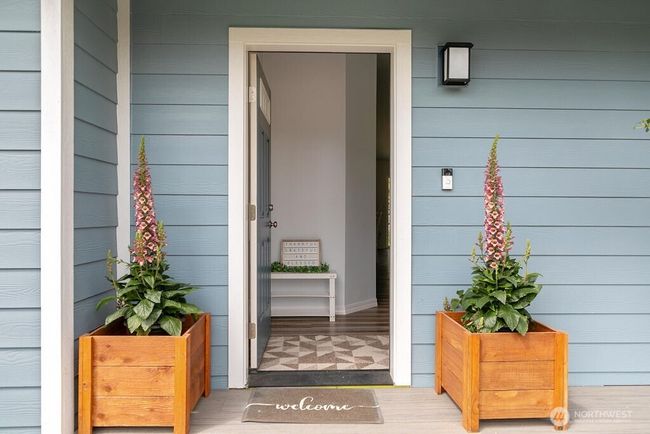 Front entrance into this easy living floor plan with a home built in 2021 and has waterviews from living room, kitchen & bedrooms | Image 26