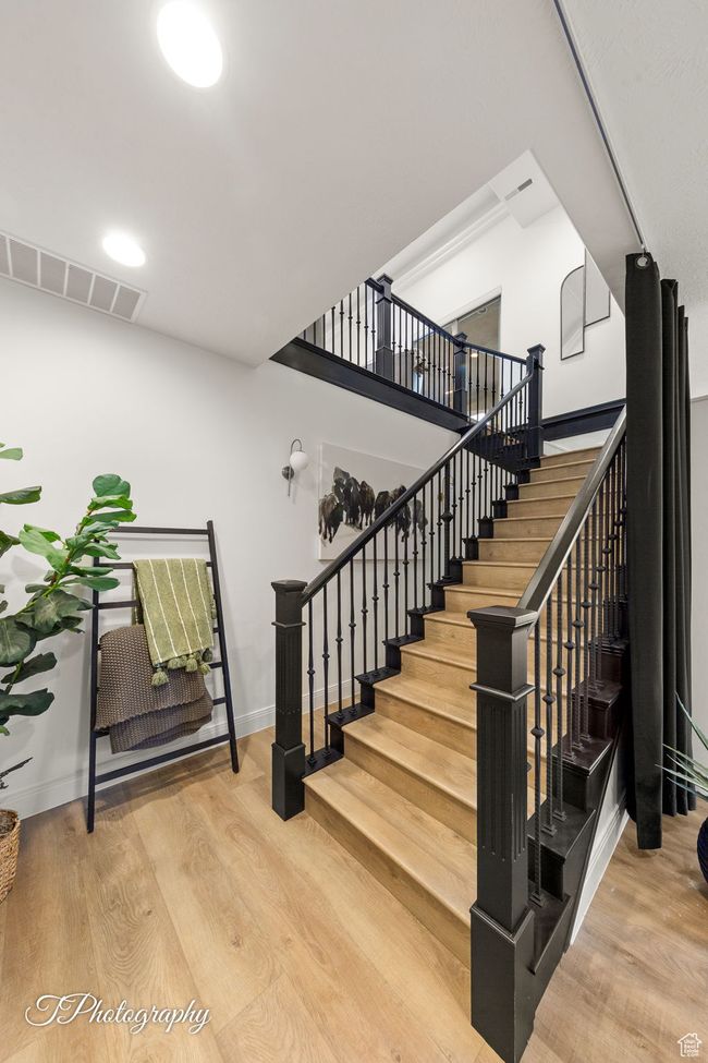 Stairs featuring wood finished floors and baseboards | Image 38