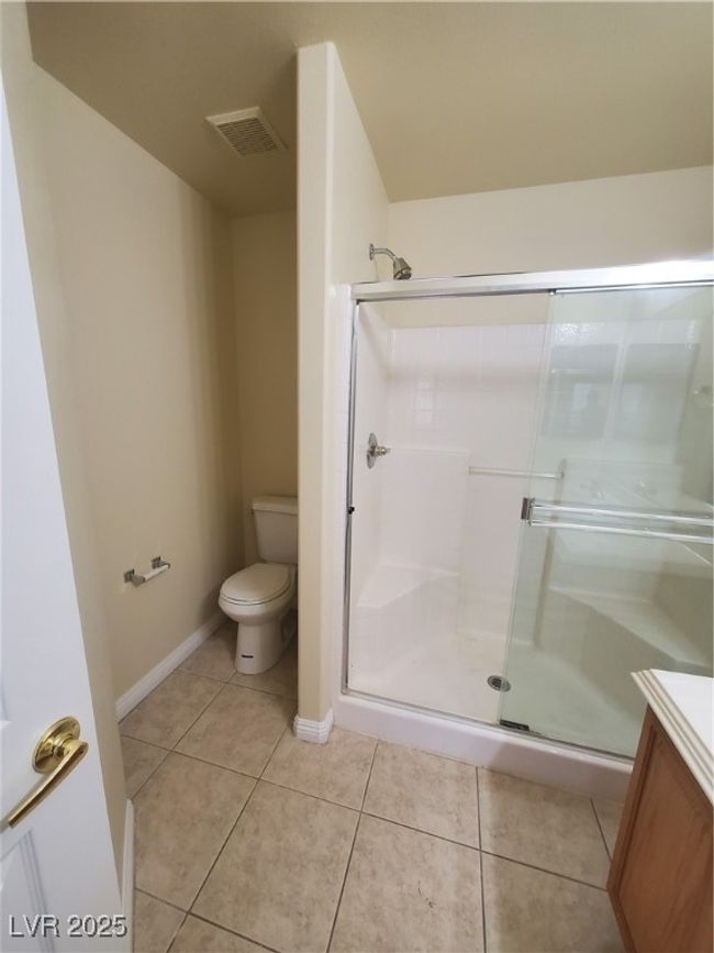 Bathroom featuring vanity, toilet, a shower stall, tile patterned floors, and visible vents | Image 14