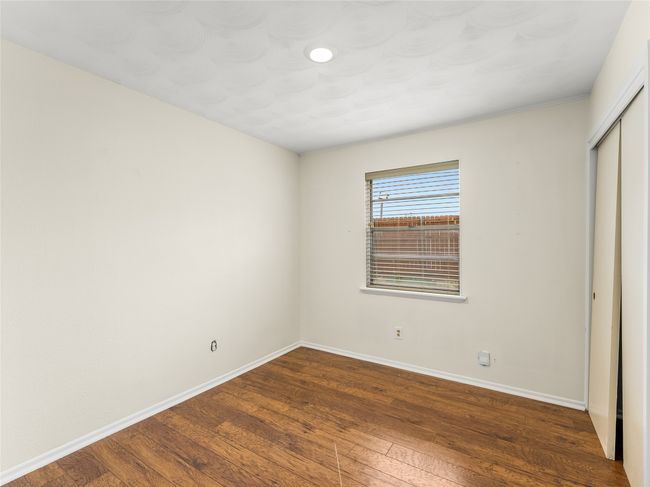 Unfurnished bedroom with dark wood-type flooring and a closet | Image 21