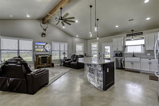 Living area with ceiling fan & beam ceiling. Open to the kitchen | Image 10