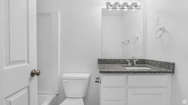 Full bathroom featuring toilet, tub/shower and vanity | Image 13