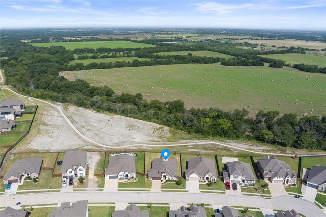 Aerial view of property's location featuring nearby suburban area and rural landscape | Image 38