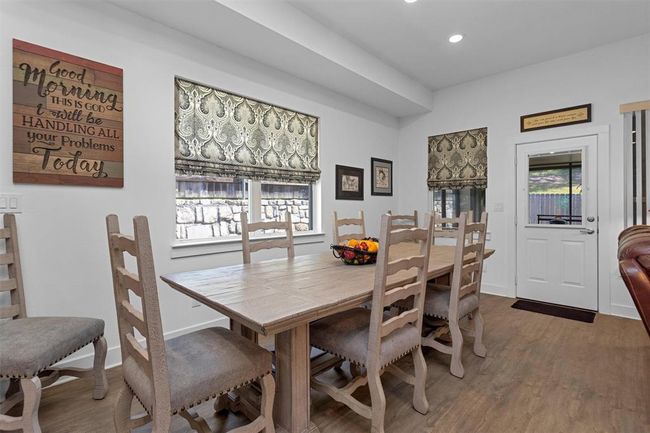 The open-concept dining area flows effortlessly from the kitchen and living room, creating a seamless space for meals and memorable gatherings. | Image 9