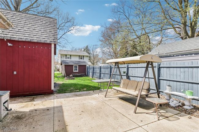 View of patio featuring an outbuilding, a shed, and a fenced backyard | Image 29