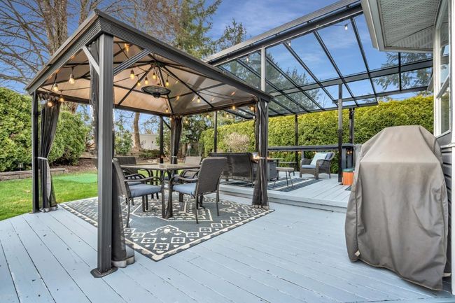 Wooden terrace featuring a gazebo, a grill, and a lanai | Image 31