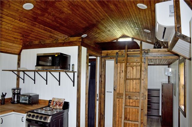 Kitchen featuring appliances with stainless steel finishes, wooden counters, lofted ceiling, wood ceiling, and wood finished floors | Image 21