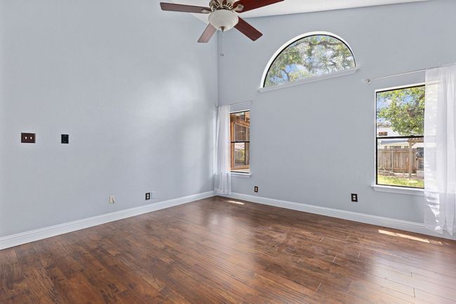 That half-moon window up top doesn’t just bring in more light—it frames the trees outside like a piece of art. With soft natural light streaming in from three sides. | Image 22