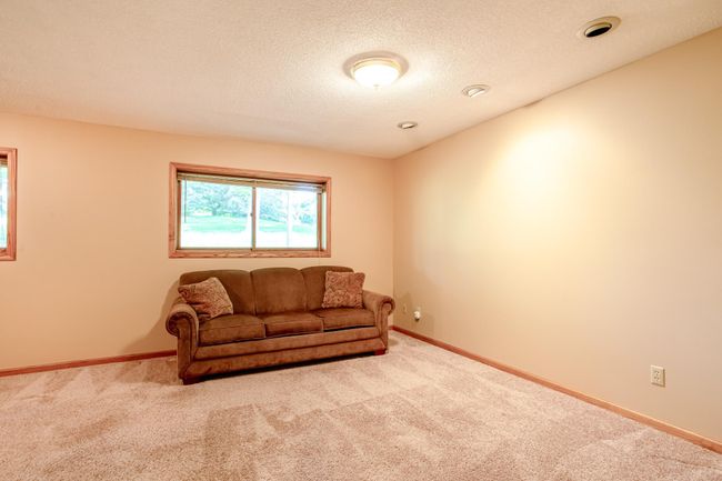 A quiet lower level family room retreat with recessed lighting and plush carpeting. | Image 22