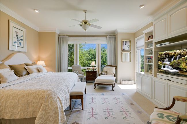 Primary bedroom featuring molding, ceiling fan and doors to the outdoor back patio | Image 17