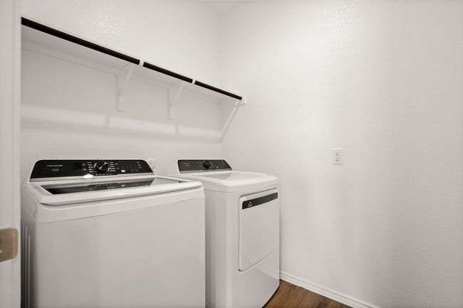 Clothes washing area with laundry area, separate washer and dryer, dark wood finished floors, and baseboards | Image 11