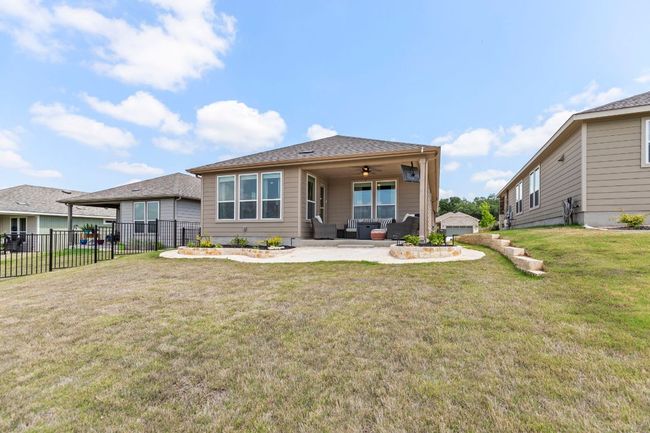 Back of house featuring fence, a lawn, ceiling fan, a patio, and an outdoor living space | Image 31
