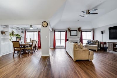 Living room featuring lofted ceiling, ceiling fan, plenty of natural light, and dark wood-type flooring | Image 3