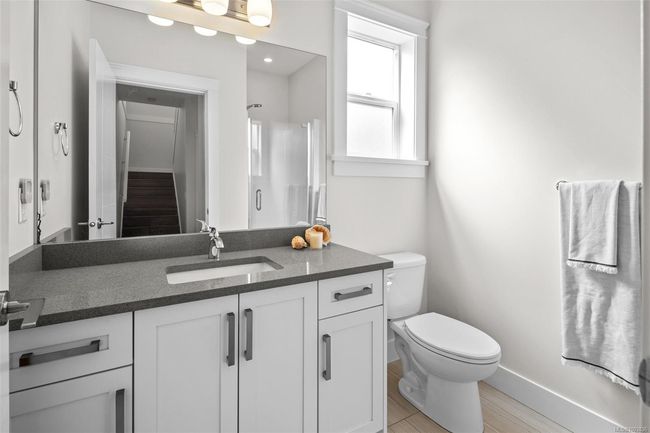 Bathroom featuring vanity, wood finished floors, and a shower | Image 8