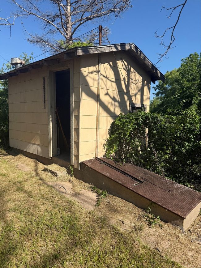 View of outdoor structure with an outbuilding and storm shelter | Image 13
