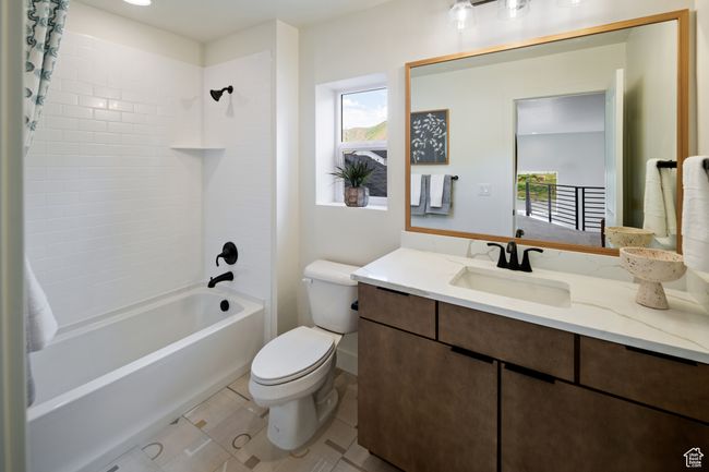 Bathroom with healthy amount of natural light, toilet, shower / bath combination with curtain, and vanity | Image 22