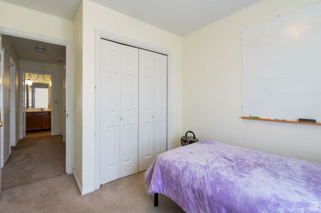 Bedroom with a closet and light carpet | Image 13