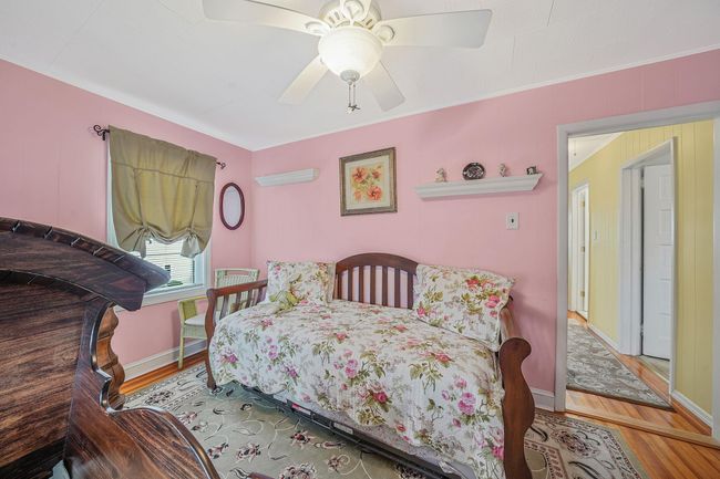 Bedroom featuring baseboards, ceiling fan, and wood finished floors | Image 20
