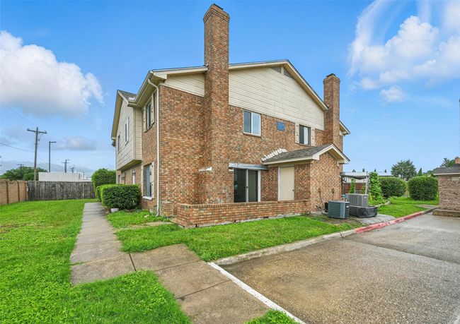 View of property exterior with brick siding and a chimney | Image 20
