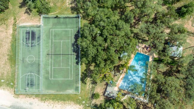 Aerial view of a pool & courts in Apache Shores | Image 23