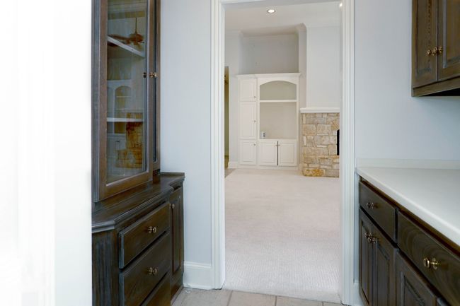 Hallway featuring ornamental molding, baseboards, and light carpet | Image 9