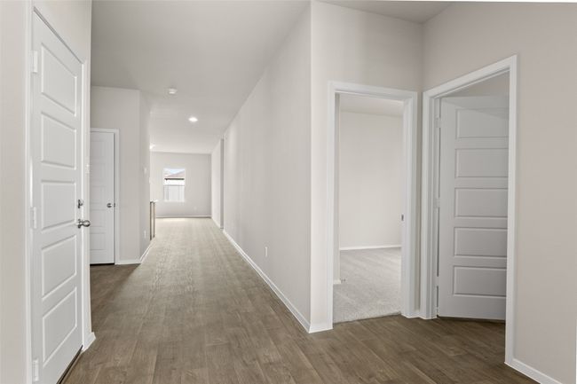Hallway featuring dark wood-style flooring, baseboards, and recessed lighting | Image 15