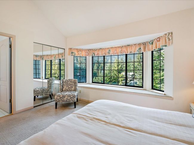 Bedroom with carpet, lofted ceiling, and baseboards | Image 16
