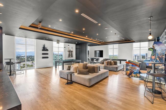Living room with a tray ceiling, expansive windows, healthy amount of natural light, and wood finished floors | Image 29