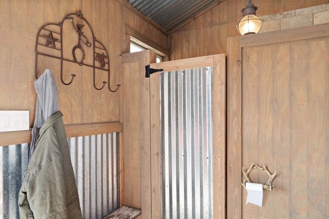 Bathroom featuring wooden walls and vaulted ceiling | Image 23