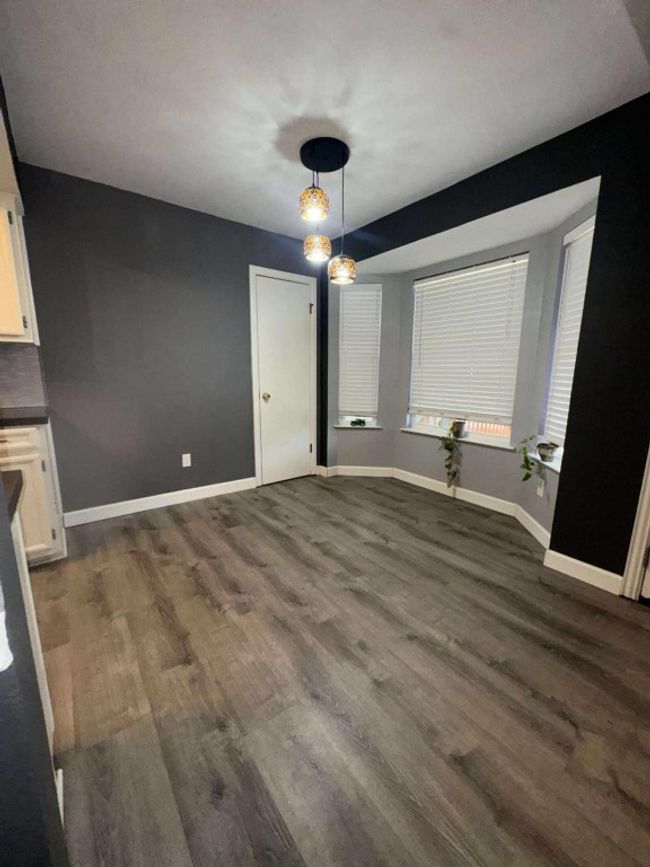Unfurnished dining area featuring dark wood finished floors | Image 4
