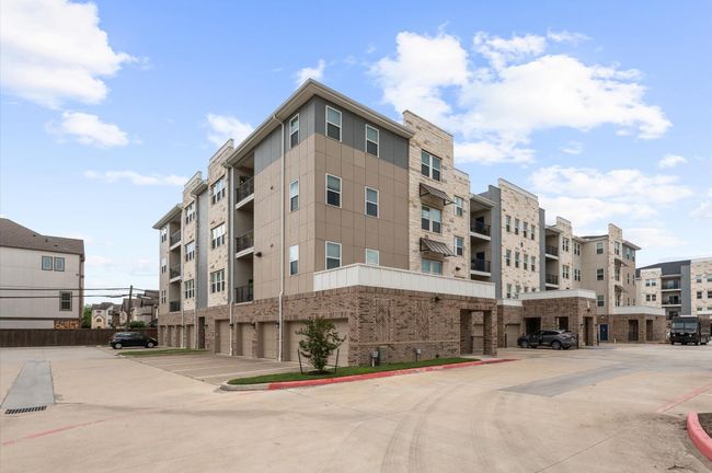 Modern construction with clean architectural lines, private garages, and ample guest parking in a gated community setting. | Image 20