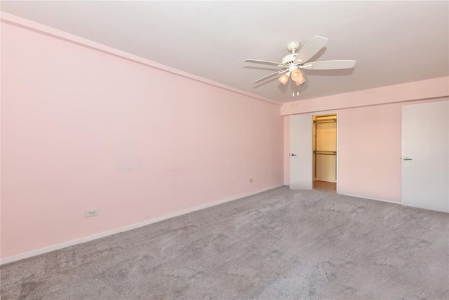 Unfurnished bedroom featuring a spacious closet, ceiling fan, carpet floors, and a closet | Image 15