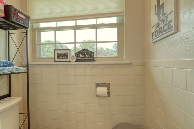Half bath featuring tile walls and wainscoting | Image 30