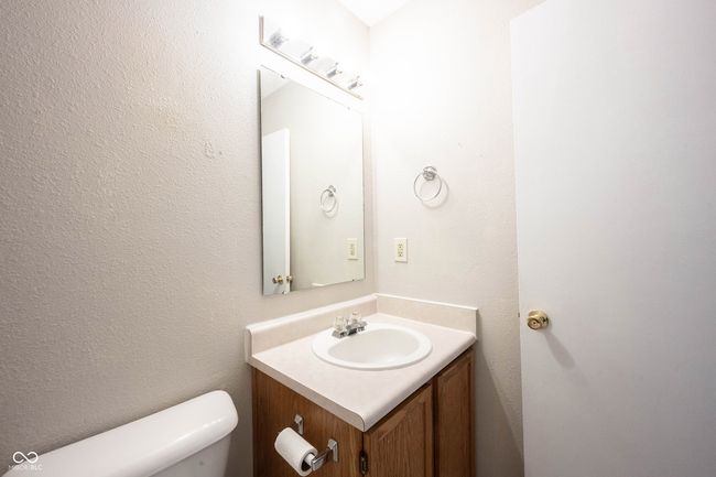 half bathroom featuring toilet and vanity | Image 27