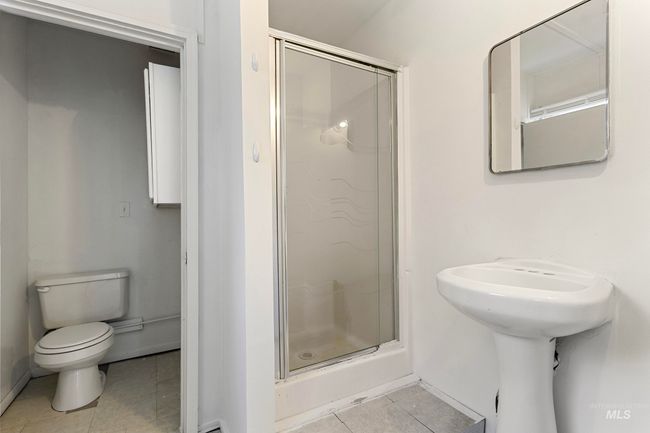 Full bathroom featuring tile patterned flooring and a stall shower | Image 26