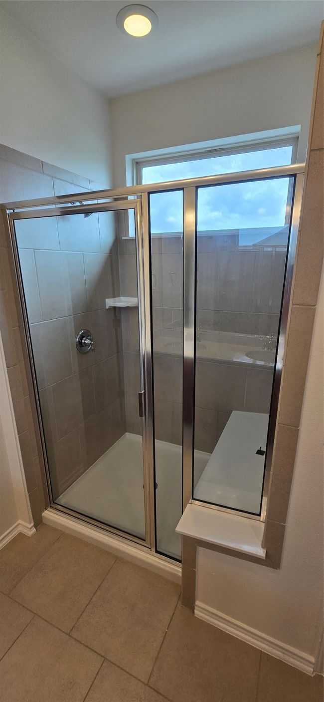 Full bath with tile patterned floors and a stall shower | Image 21